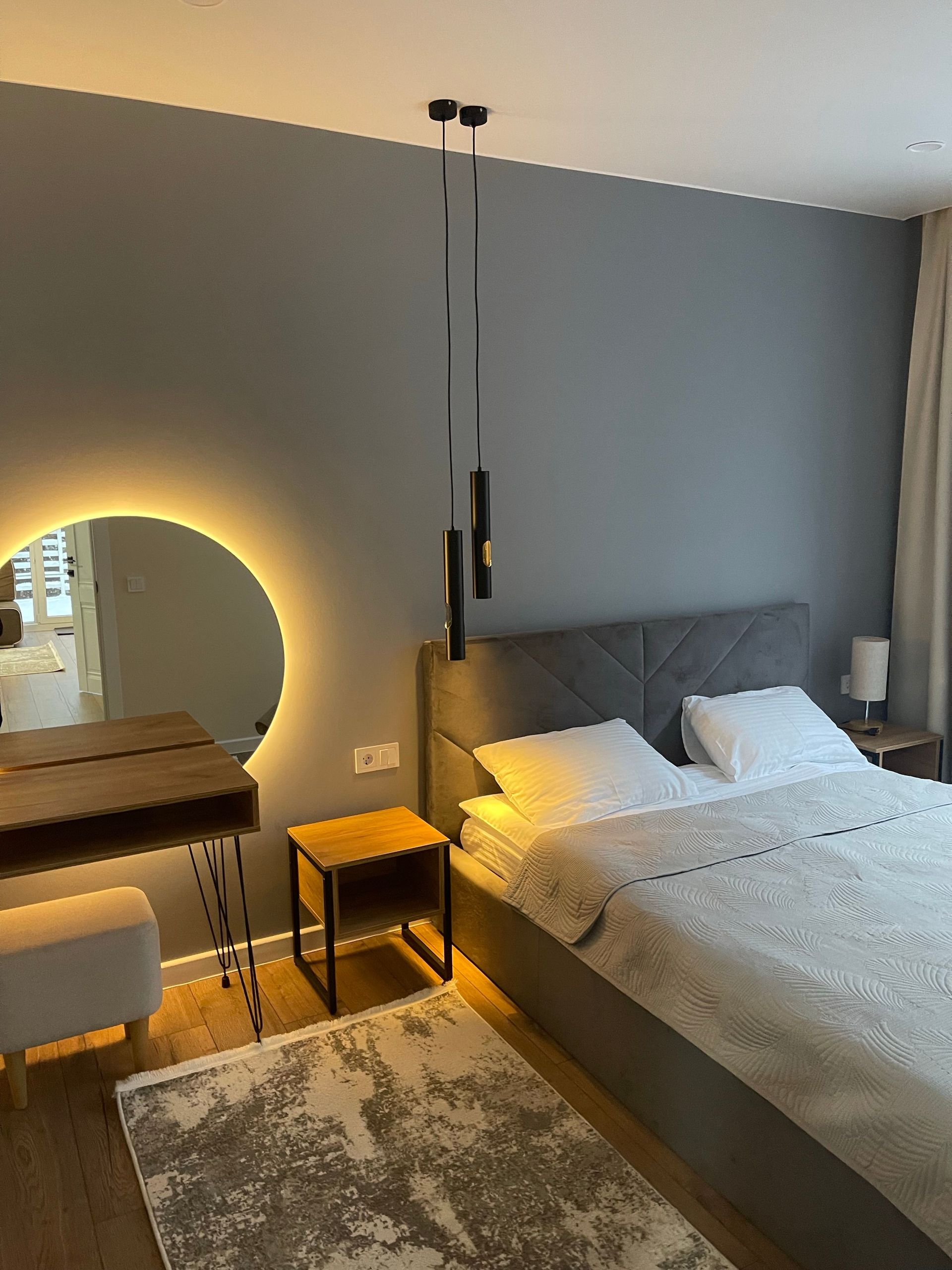 Contemporary hotel bedroom with elegant decor and soft lighting for a cozy ambiance.